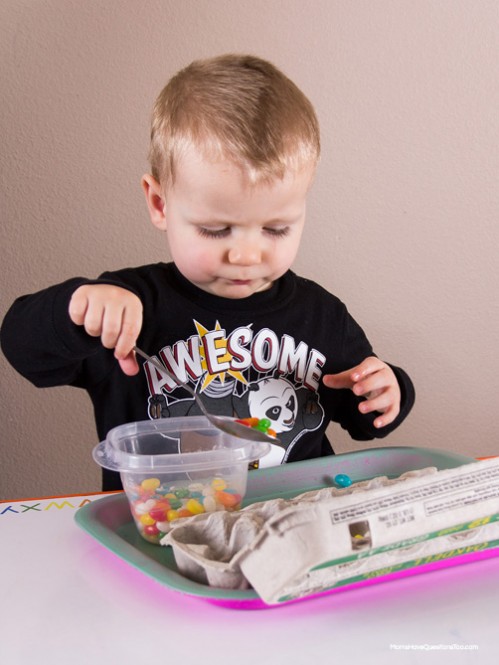 Spoon Jelly Beans into Egg Carton - Easter Themed Tot School Trays -- Moms Have Questions Too