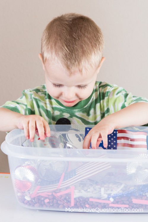 Playing with a 4th of July Sensory Bin - www.momshavequestionstoo.com