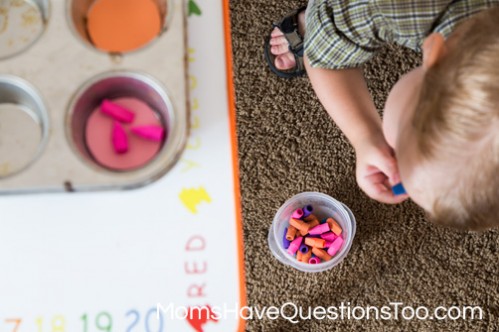 Sorting erasers by color from floor to table for gross motor development - Moms Have Questions Too