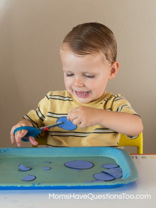Cutting practice for toddlers on circle tot school trays - Moms Have Questions Too