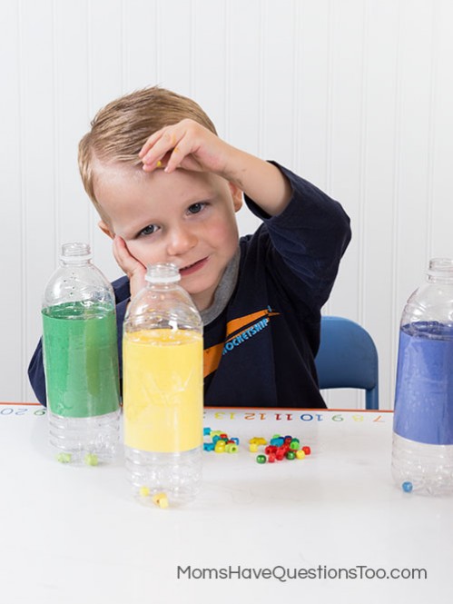 Toddler activity - putting beads in a waterbottle - Moms Have Questions Too