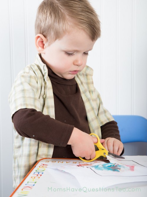 Cutting out the house for the cut and paste activity - Moms Have Questions Too