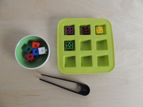 Transfer math cubes into an ice cube tray using tongs