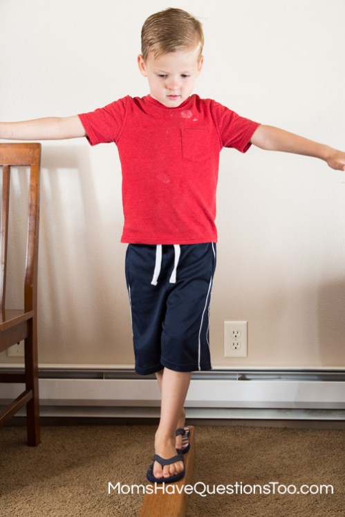 Walking on a balance beam to develop gross motor skills - Moms Have Questions Too