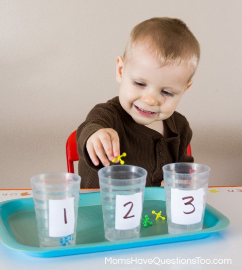 Teach numbers and counting with tot trays. Ideas for number cards, numbered cups and objects, printables, and dice activities.