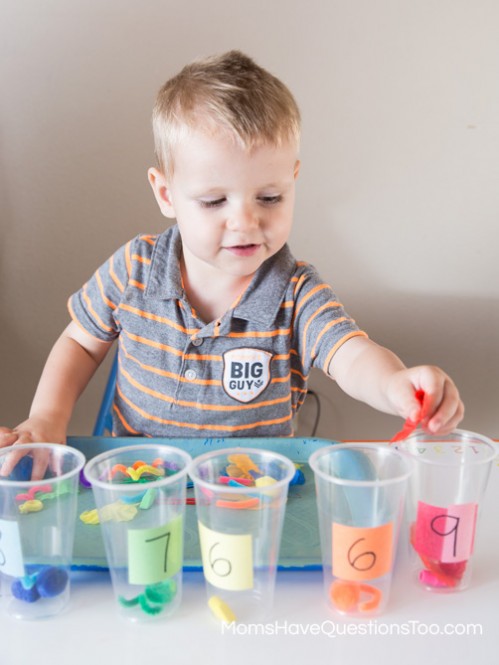 Teach numbers and counting with tot trays. Ideas for number cards, numbered cups and objects, printables, and dice activities.