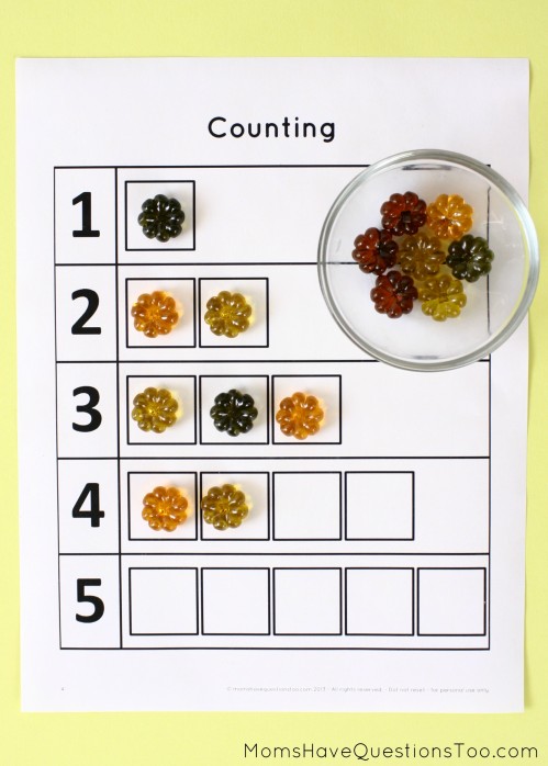 15 toddler activities that use table scatter (also called math manipulatives). These teach counting, creativity, fine motor, and more!
