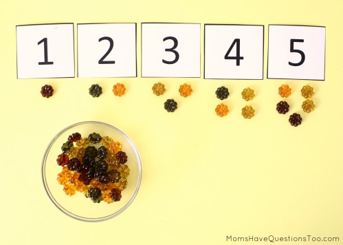 15 toddler activities that use table scatter (also called math manipulatives). These teach counting, creativity, fine motor, and more!