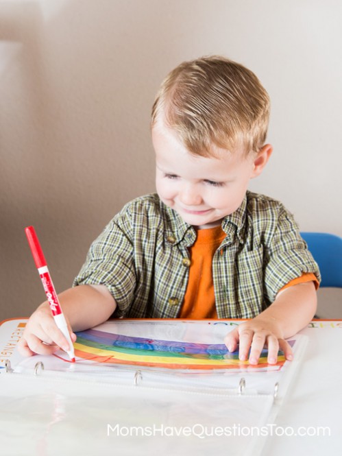 Coloring the rainbow in the toddler learning notebook - Moms Have Questions Too