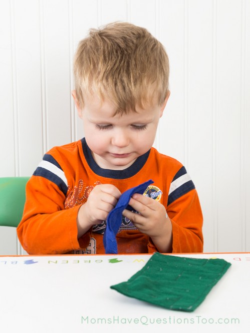 Toddler using felt marble maze - Moms Have Questions Too