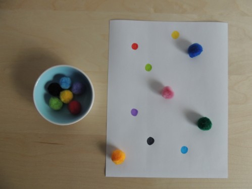Match pompoms to colored dots on paper