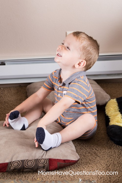 Having fun walking on pillows for gross motor skills development - Moms Have Questions Too