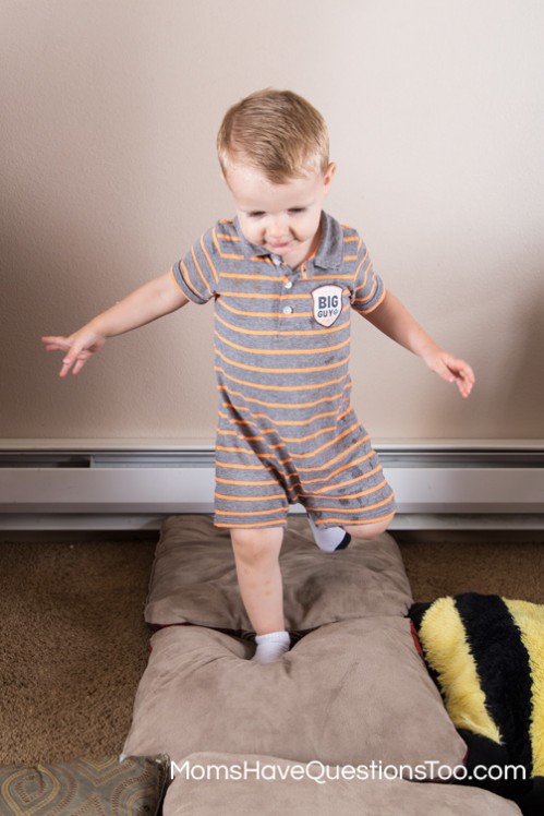 Help your toddler improve their gross motor skills by walking on pillows - Moms Have Questions Too